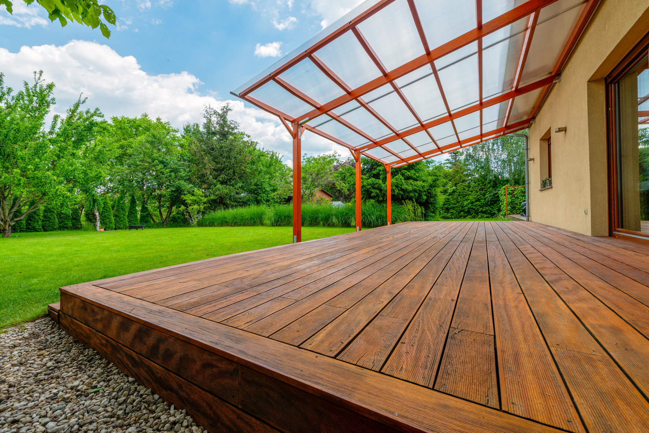 Custom-built wooden deck with patio cover in backyard setting — expert Carpentry project in Flagstaff AZ.
